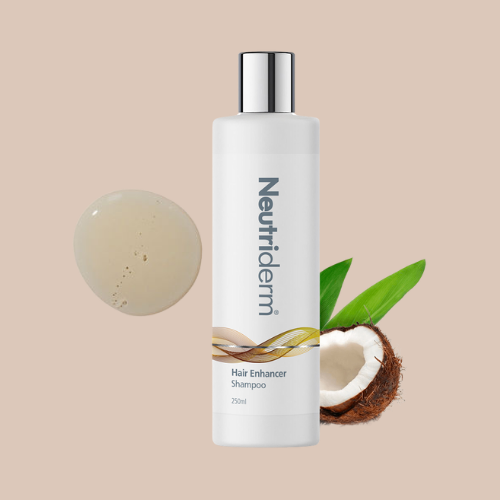 250ml bottle of Neutriderm Hair Enhancer Shampoo alongside coconut and a product swatch, styled in a lifestyle setting. 